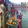 Women giving aragh on Chhath Puja